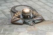 bronze statue in a manhole cover